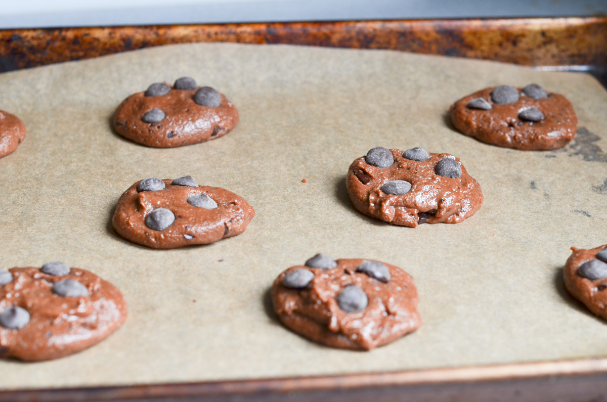 chocolate peppermint cookies on parchment lined baking sheet ready for the oven.