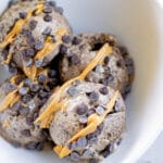 scoops of banana ice cream with drizzles of peanut butter and chocolate chips.