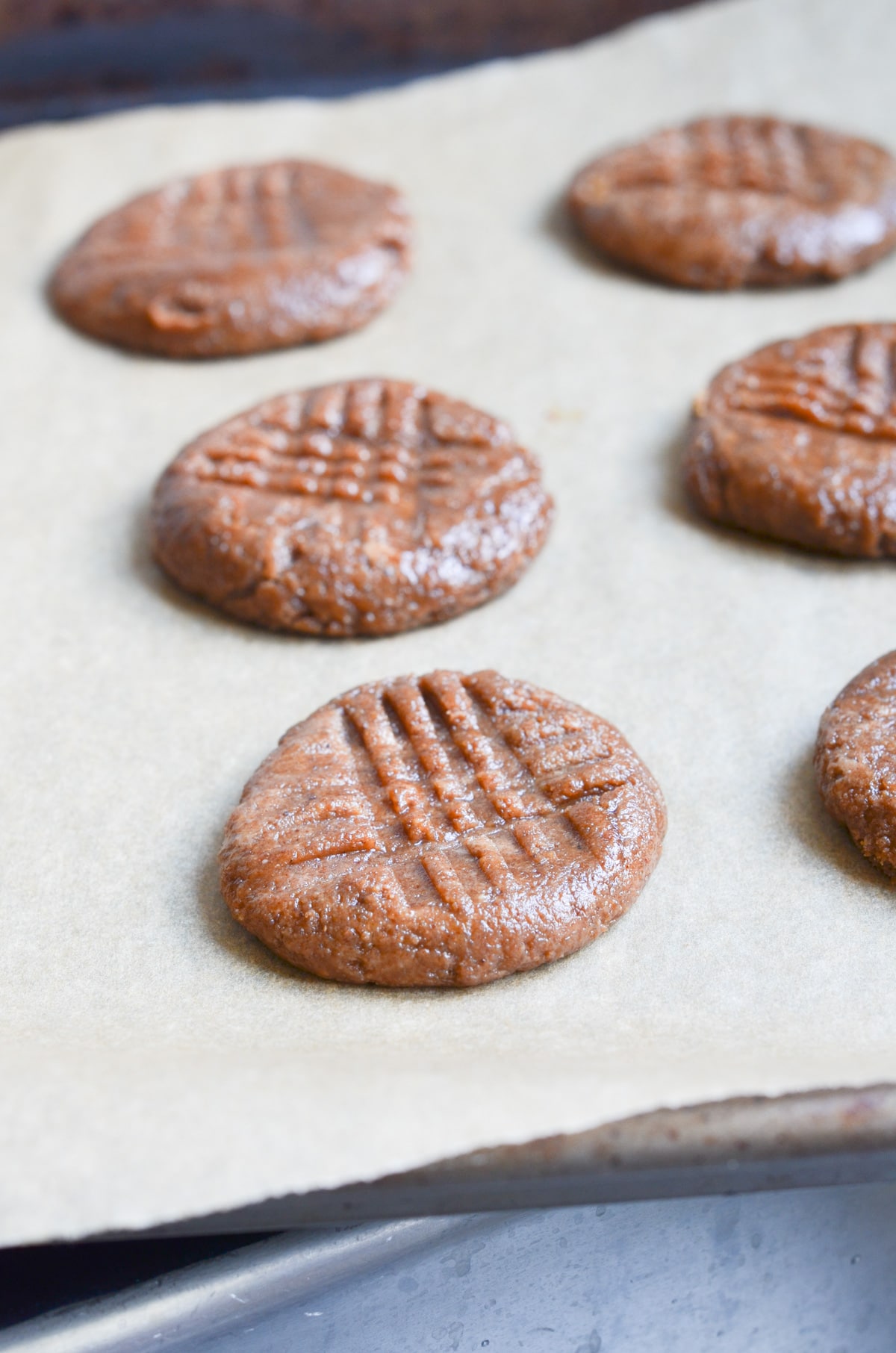 almond butter cookies on baking pan ready for oven.