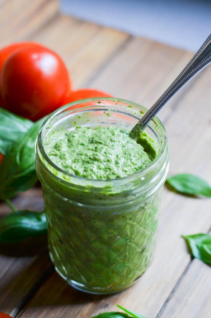 Dairy-free pesto in a glass jar.