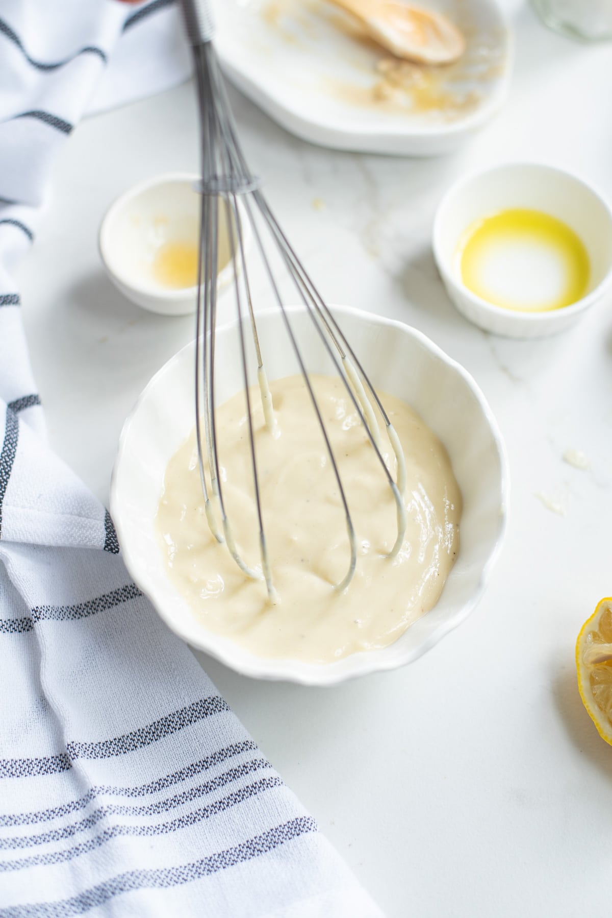 mixing tahini dressing in a bowl.