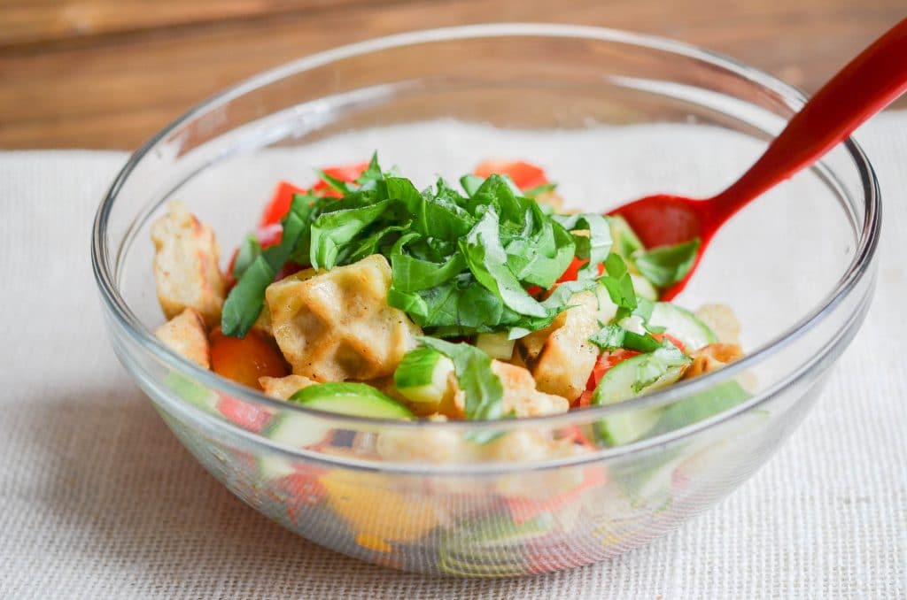 Panzanella salad ingredients in a bowl.