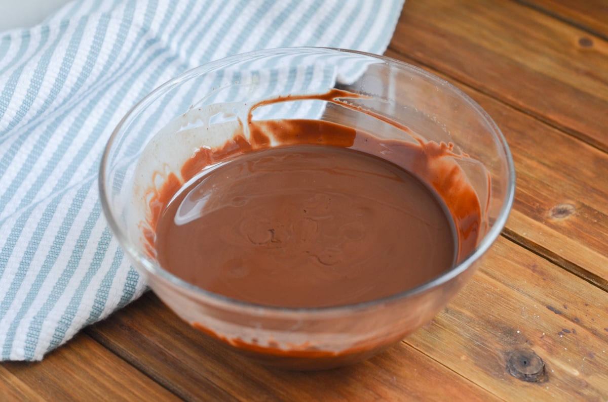 chocolate shell recipe in glass bowl on counter.