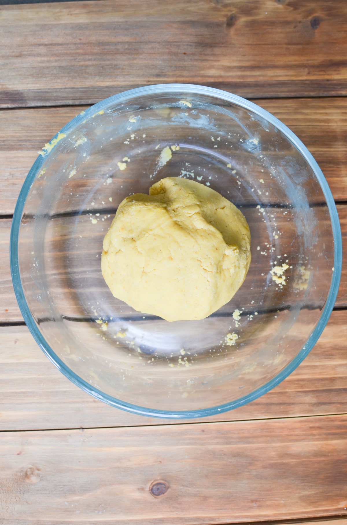 peanut butter dog treat dough rolled into a ball in a mixing bowl.