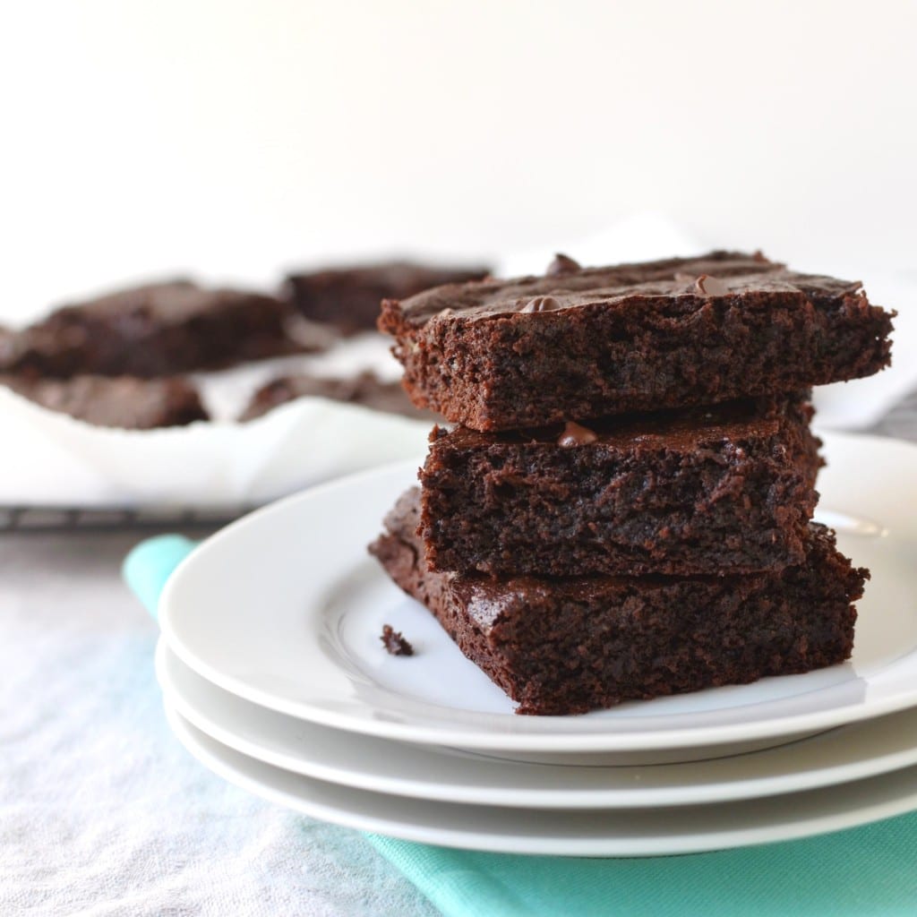 Flourless Brownies stacked on a plate - 24 Carrot Kitchen