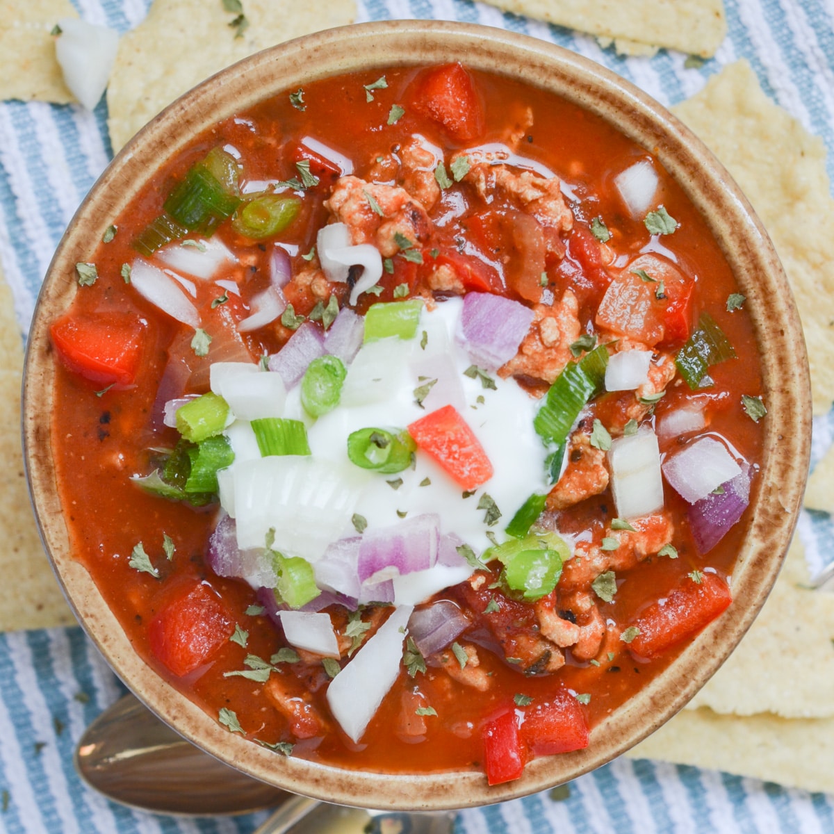 turkey chili in bowl with toppings.