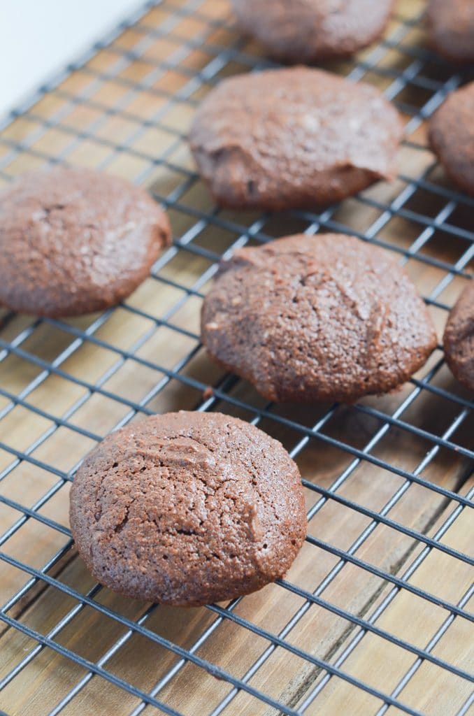 chocolate fudge cookies baked on cooling rack.