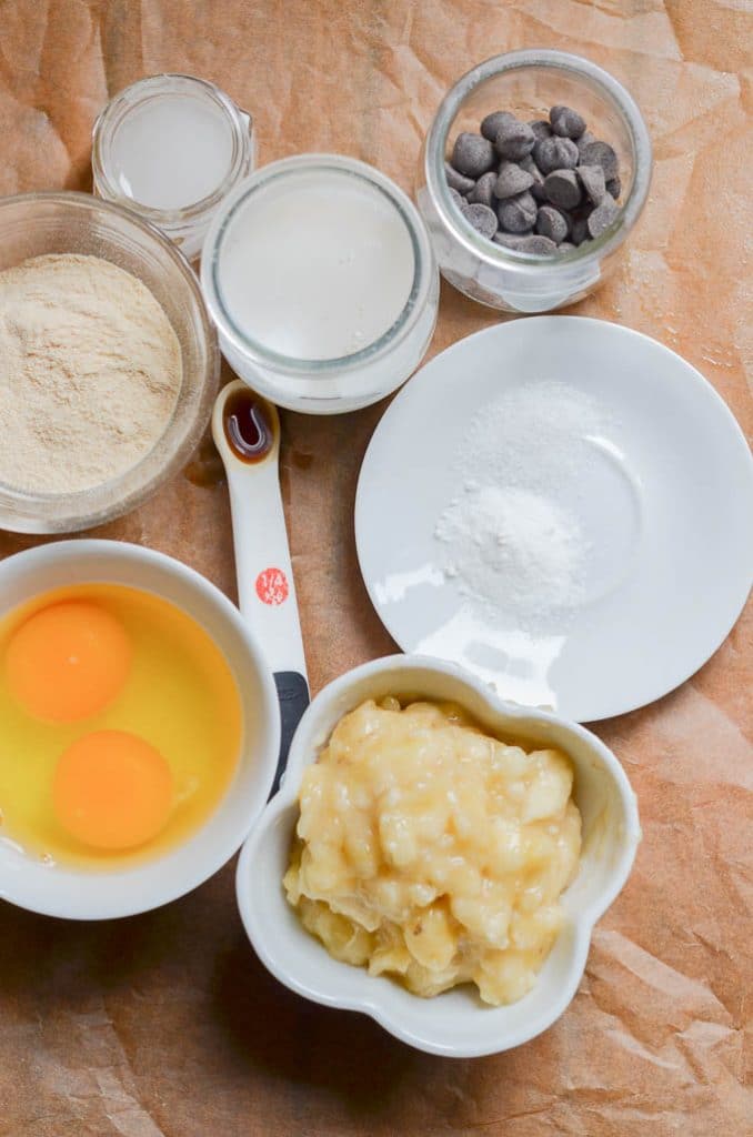 Ingredients for coconut flour muffins in bowls on counter.