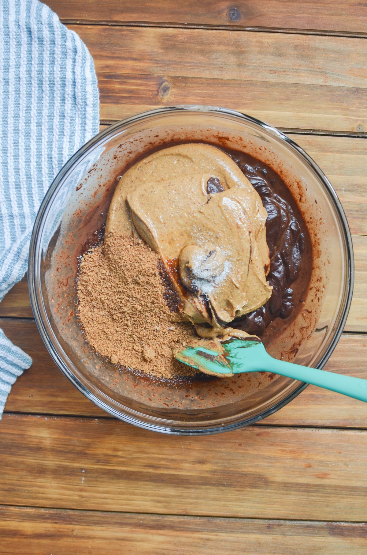 ingredients for vegan fudge in a mixing bowl with spatula.