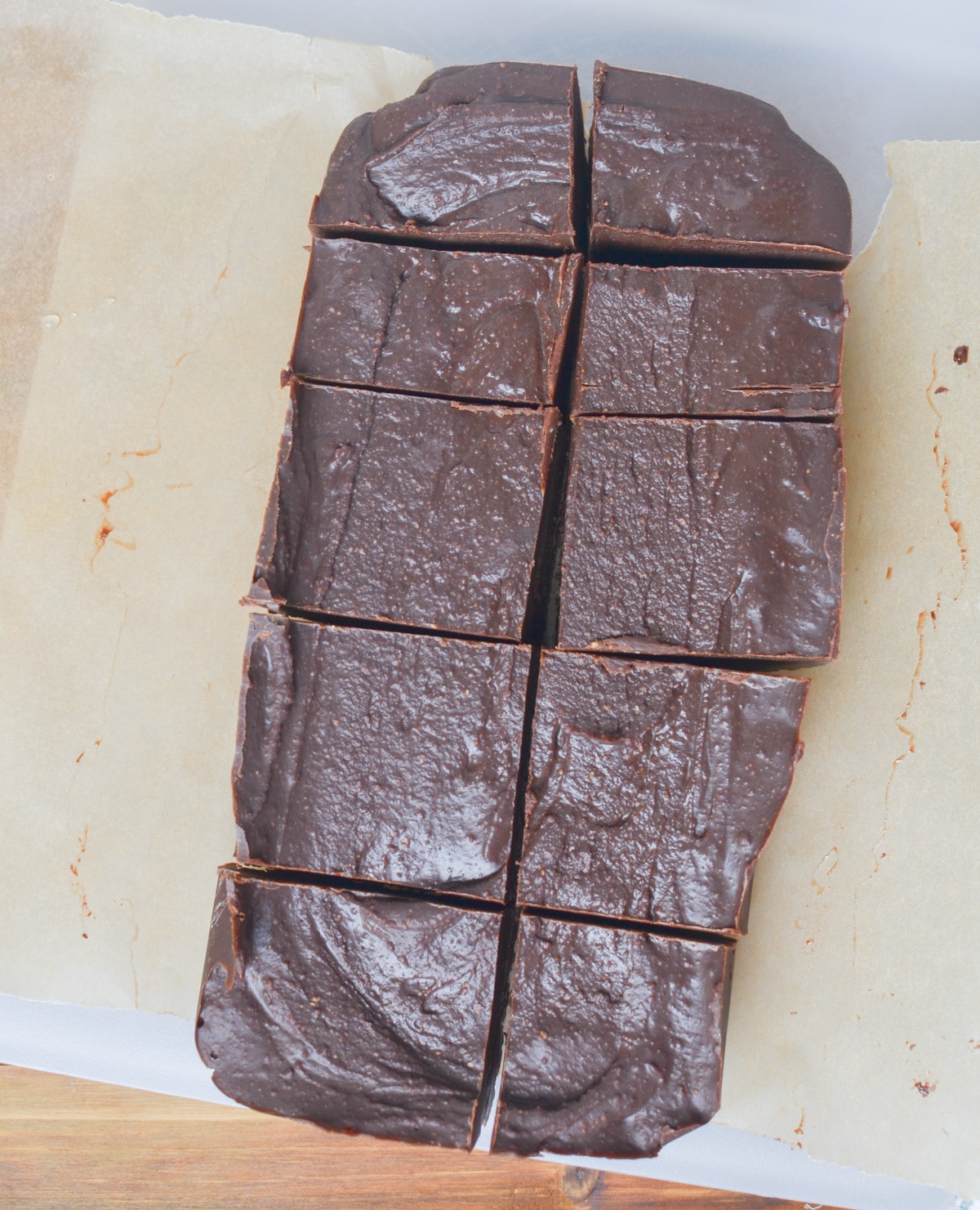 Vegan Fudge cut into pieces on parchment paper.