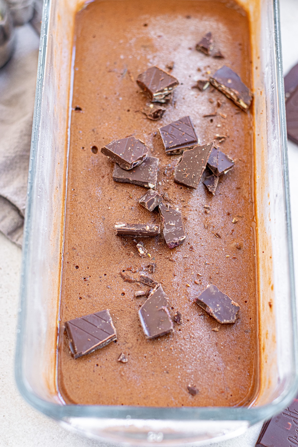 chocolate chunks on top of frozen chocolate banana ice cream.