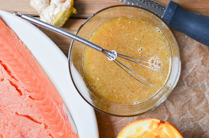 salmon and orange glaze in bowl on counter.