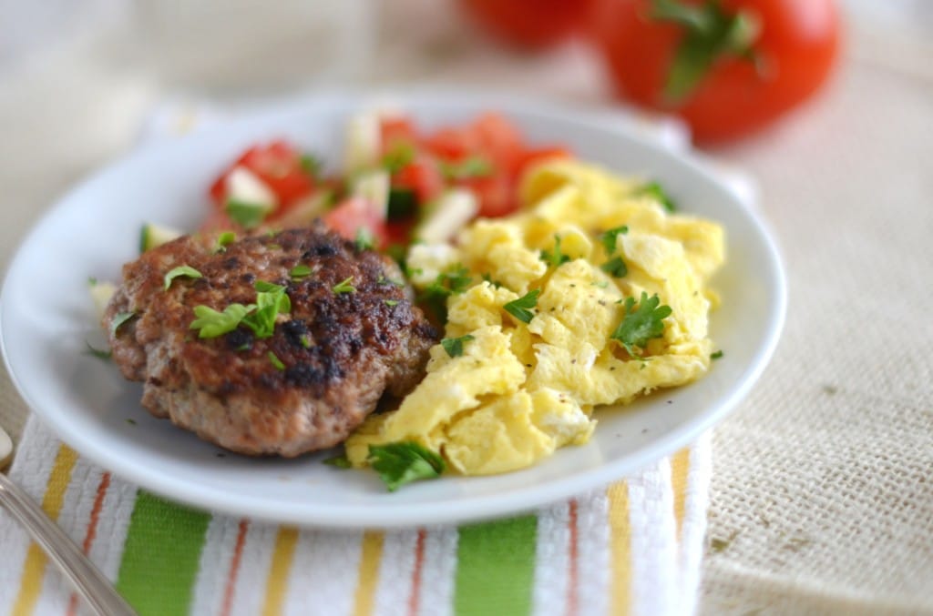 Whole30 sausage with scrambled eggs and chopped vegetables on plate - 24 Carrot Kitchen