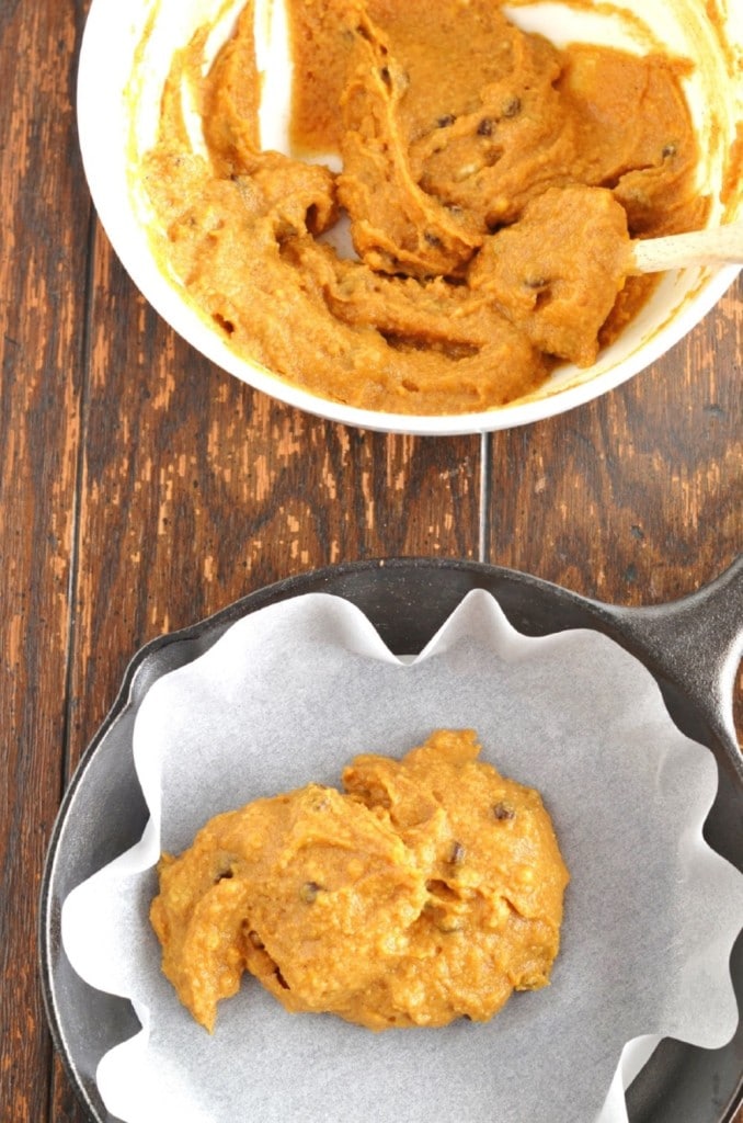 Pizookie batter in bowl and being spread in cast iron skillet - 24 Carrot Kitchen