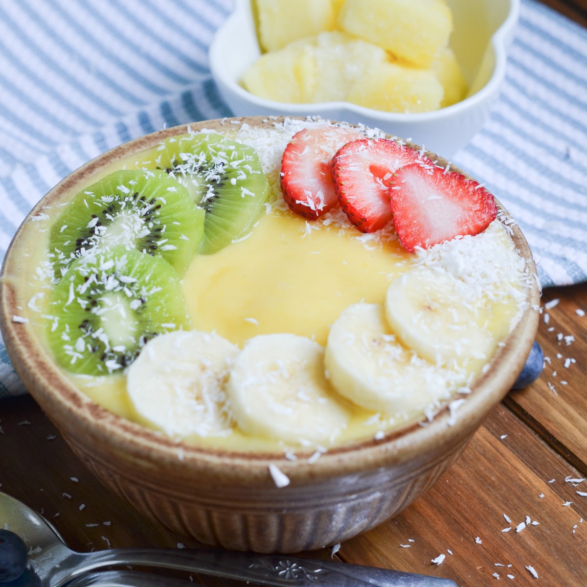 mango smoothie bowl with toppings.