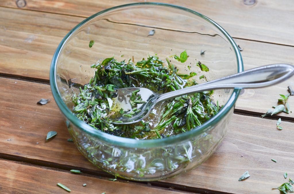 herbs, salt, pepper and olive oil in bowl.