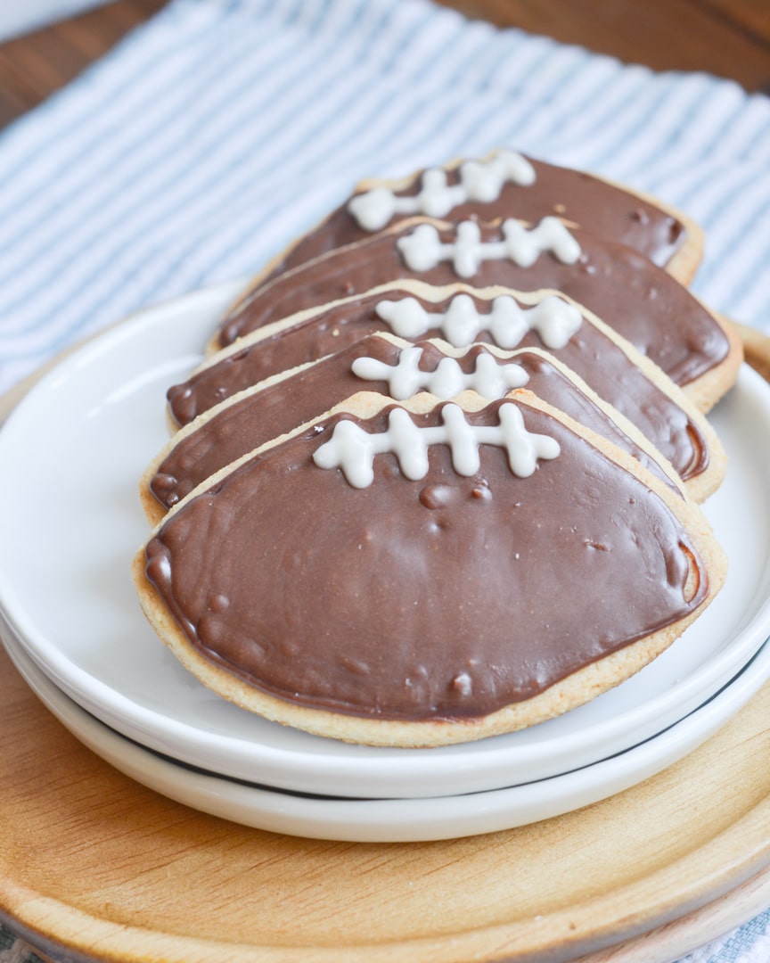 vegan sugar cookies - cutout football cookies on a plate.