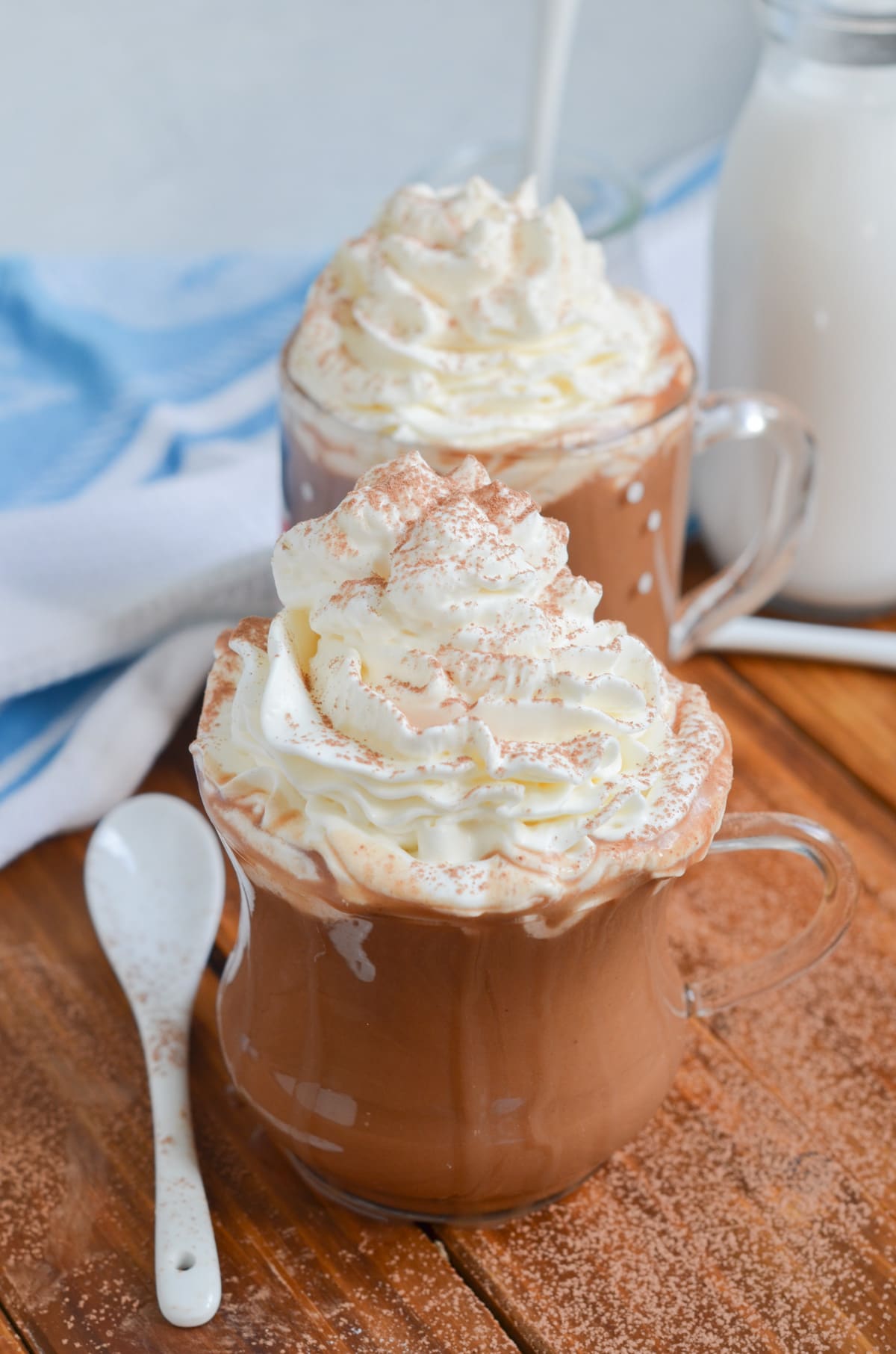 vegan hot chocolate in a glass with whipped cream.