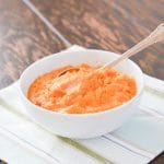 mashed sweet potatoes in bowl with spoon.