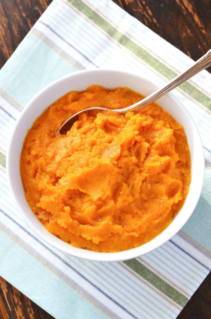 mashed sweet potatoes in bowl with spoon.