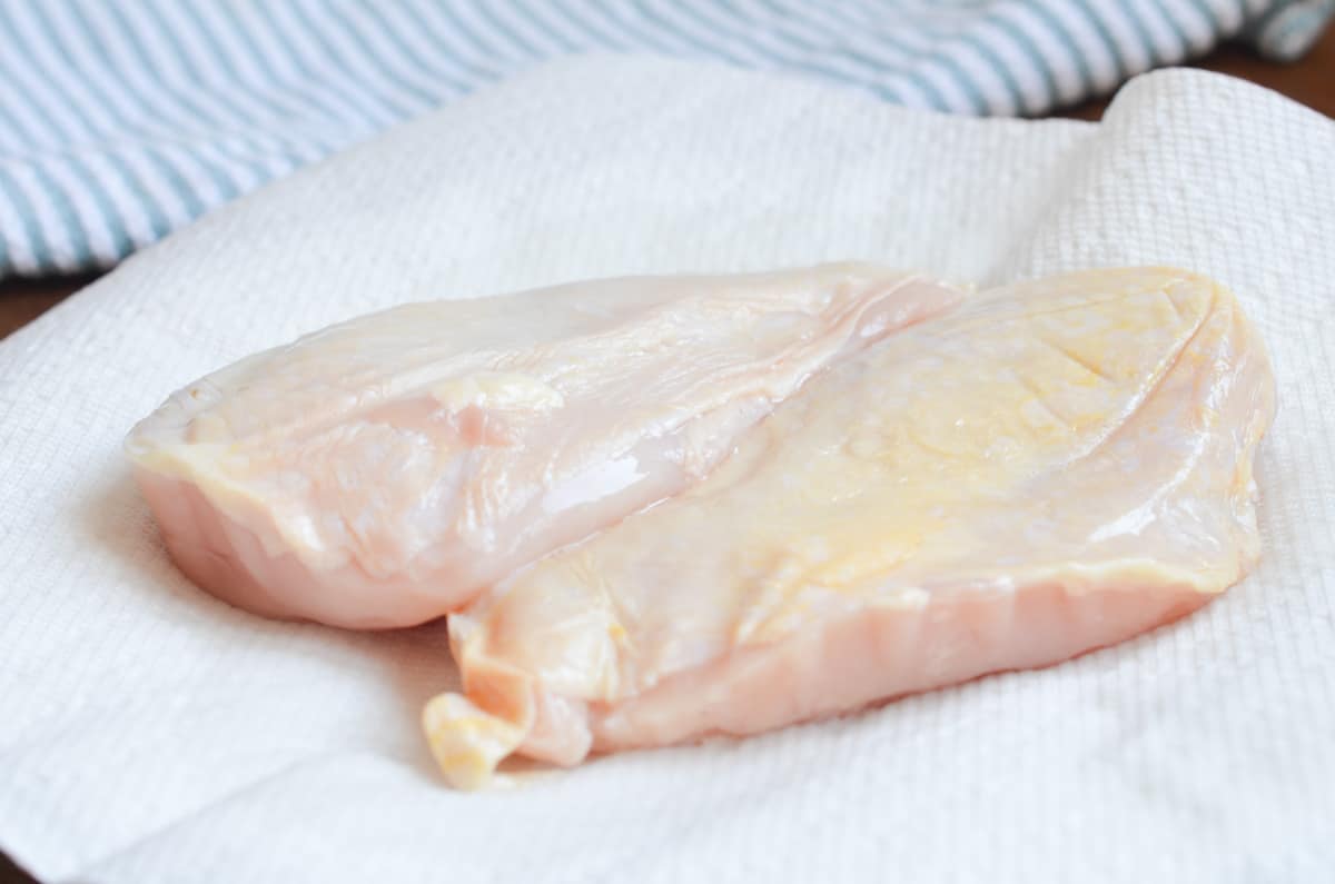 two chicken breast on plate with paper towel.