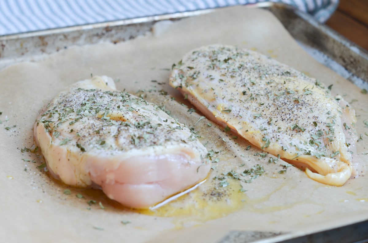 Baked chicken breasts coated in olive oil, salt, pepper and herbs.