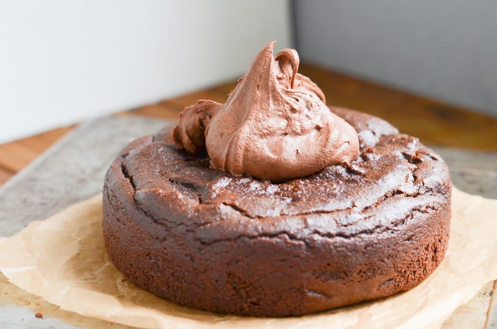 Vegan chocolate frosting on round Paleo chocolate cake.