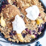 peach blueberry crumble in a cast iron skillet.