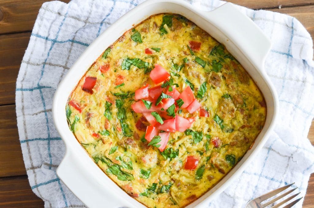 Paleo Breakfast Casserole in baking dish with chopped tomatoes garnish - 24 Carrot Kitchen