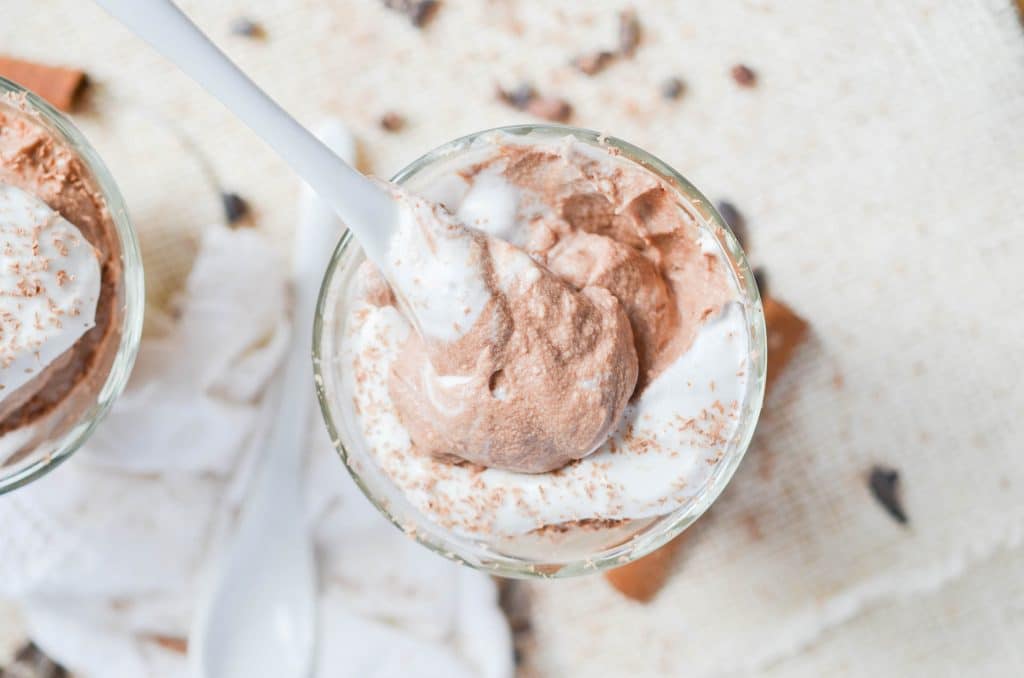 Vegan Chocolate Mousse in a bowl with coconut whipped cream - 24 Carrot Kitchen