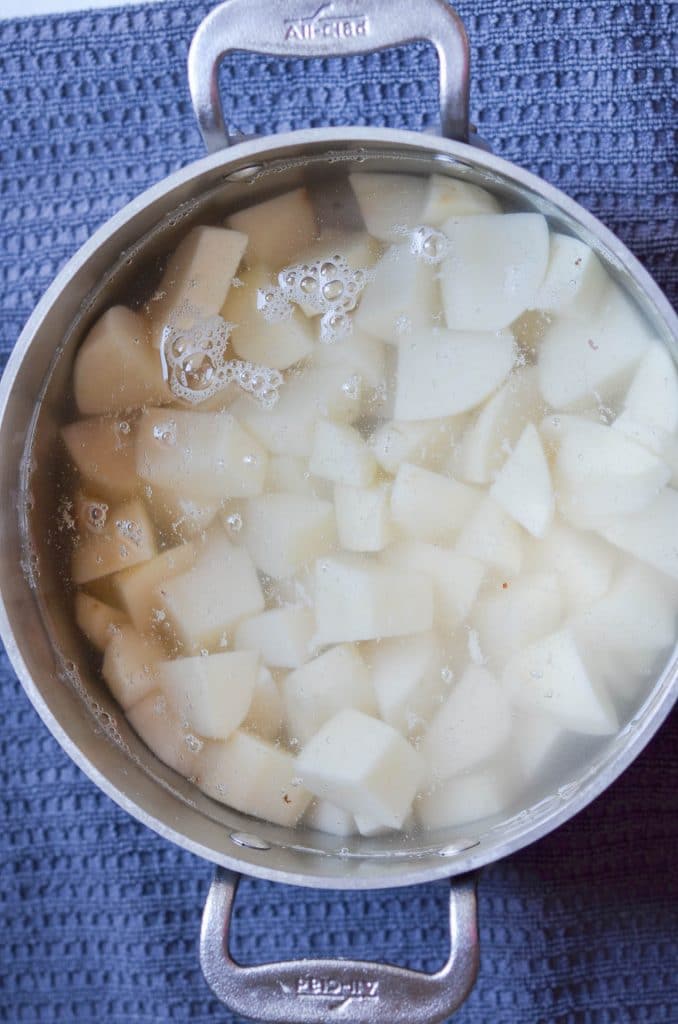 Cut Potatoes cubes in pot with water - 24 carrot kitchen