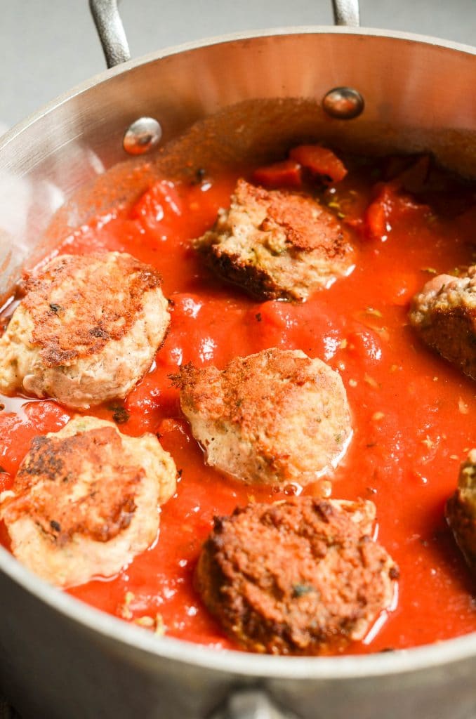 Whole30 Meatballs with tomato sauce in pot - 24 Carrot Kitchen