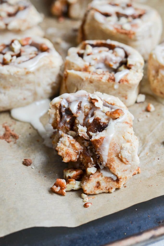 Vegan cinnamon rolls frosted on pan - 24 Carrot Kitchen