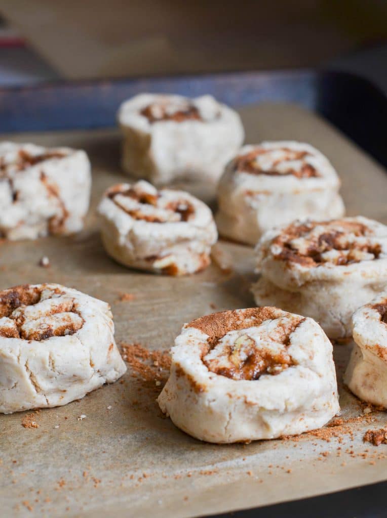 vegan cinnamon rolls on baking pan ready for oven - 24 Carrot Kitchen