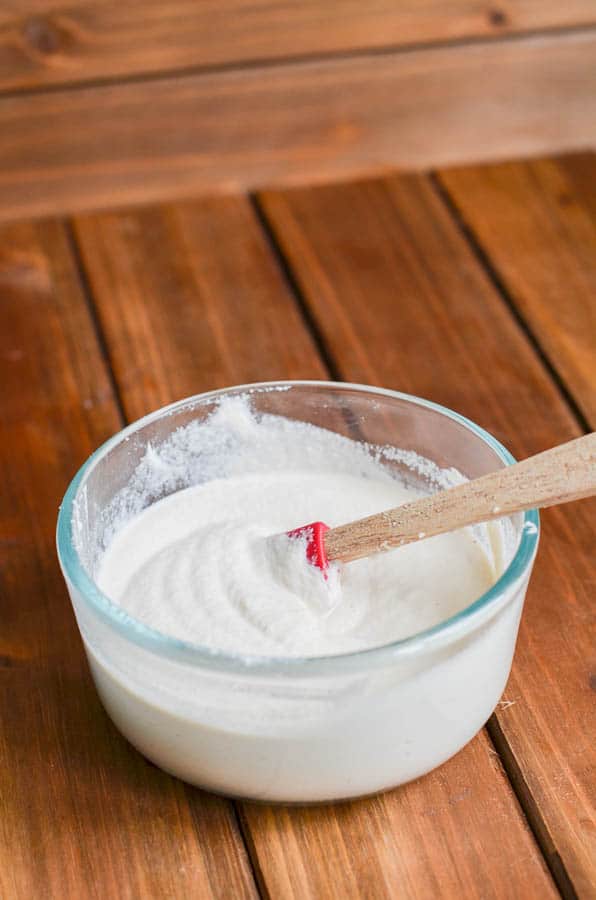 Dairy-free sour cream in glass dish with spatula - 24 Carrot Kitchen