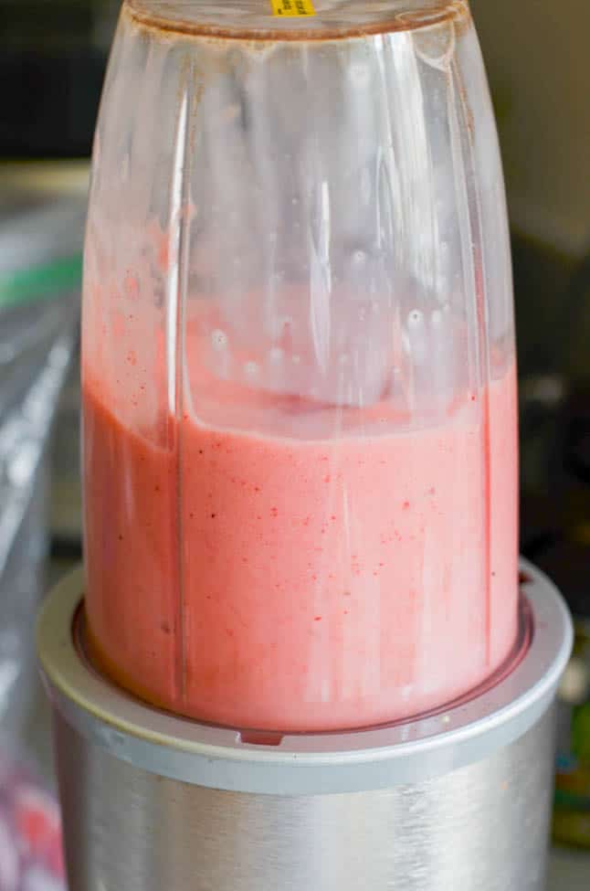 Strawberry Pineapple smoothie in blender in process of blending and turning pink!. 24 Carrot Kitchen