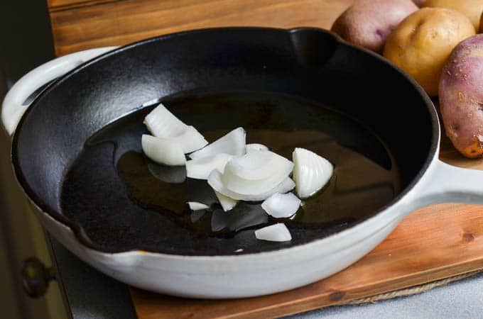 Onions cooking in cast iron skillet.