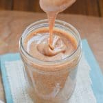 vegan caramel sauce in glass jar on counter.