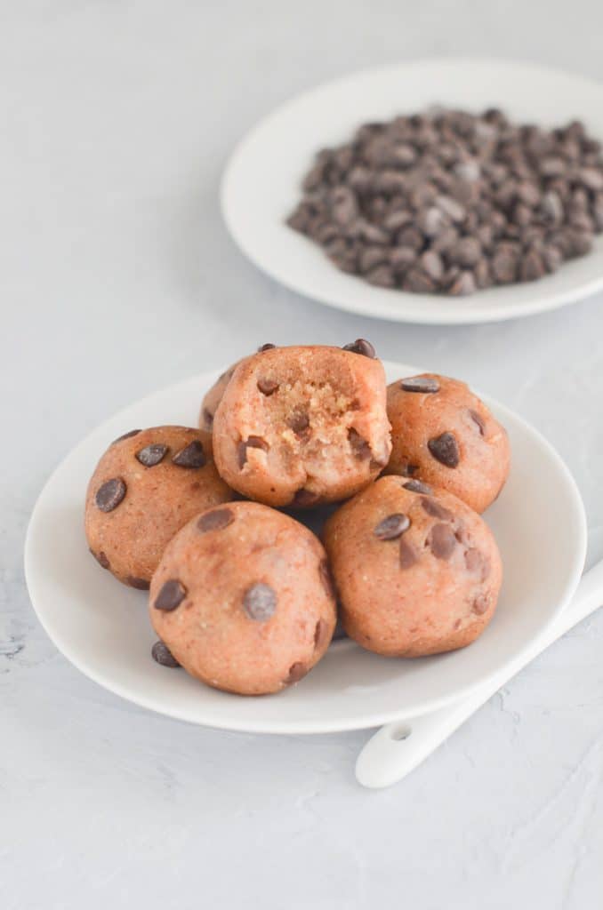 vegan cookie dough made into balls on plate.