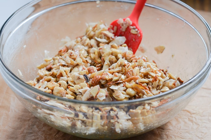 ingredients for vegan granola in glass mixing bowl.