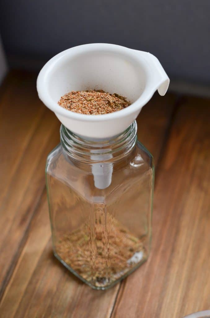 whole30 taco seasoning in a spice jar with funnel.