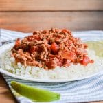 Ground turkey breast with taco seasoning over cauliflower rice on plate.