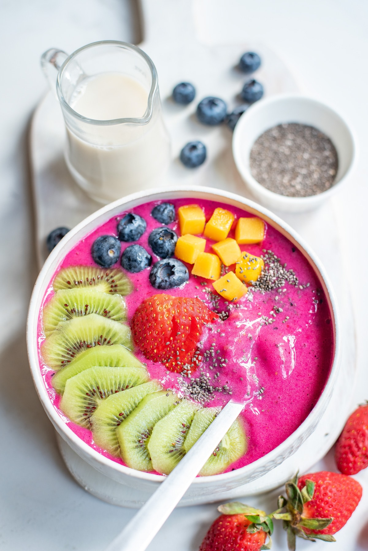 dragon fruit smoothie bowl with spoon.