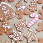 decorated gingerbread cookies on parchment lined baking sheet.