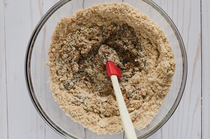 ingredients for vegan gingerbread cookies in mixing bowl with spatula.