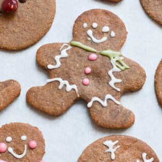 Decorated vegan gingerbread cookies on baking sheet.