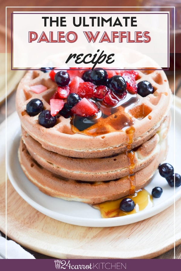 Paleo waffles on a plate with berries and maple syrup.