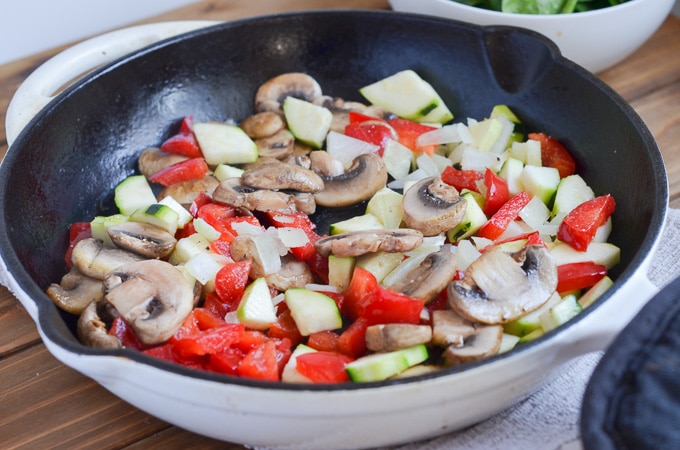 veggies sauteing in cast iron skillet.