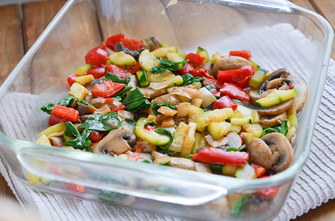 cooked veggies placed in 8 x 8 casserole dish.