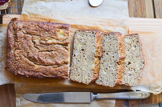 Banana bread on cutting board with slices.